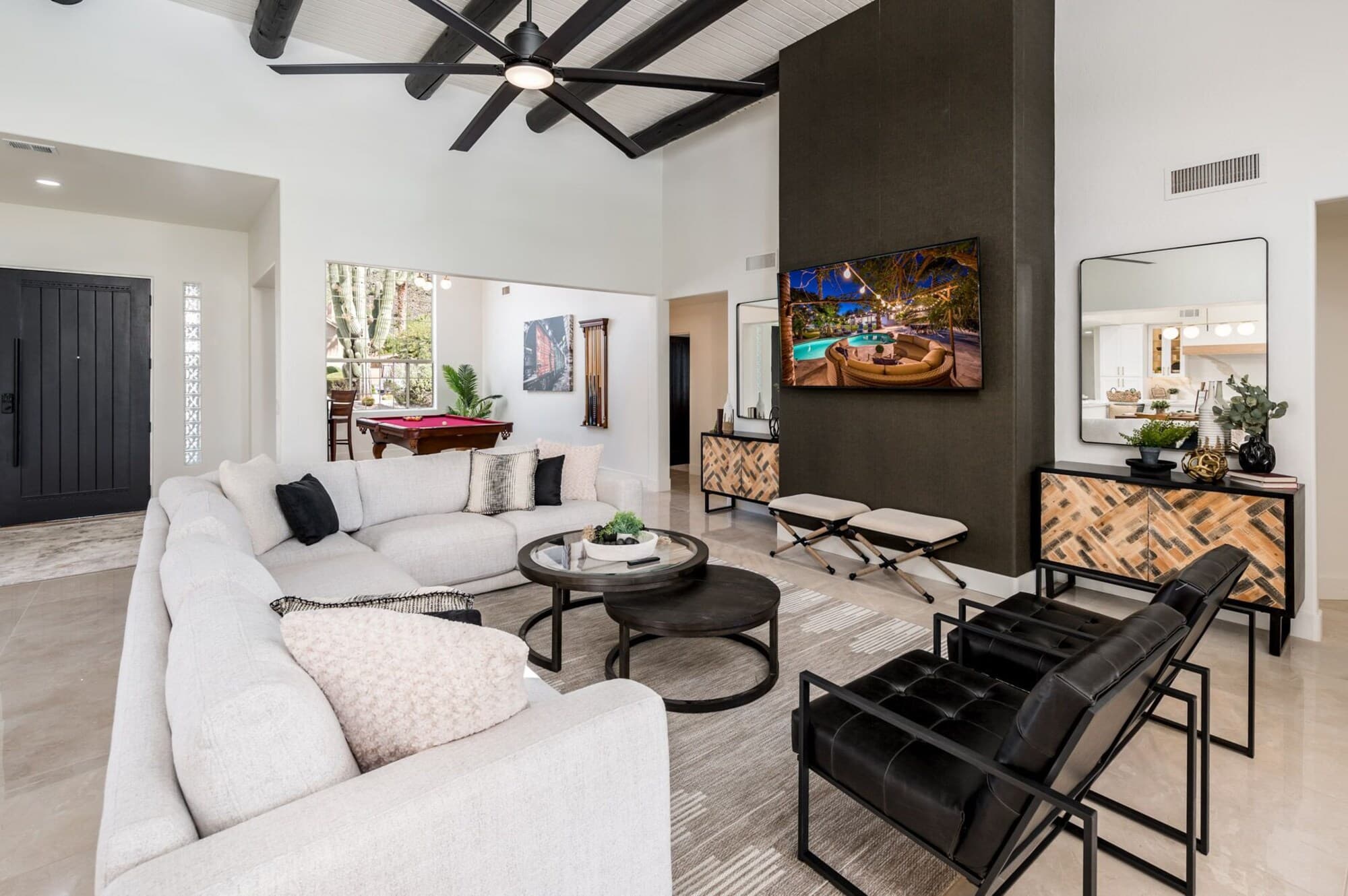 Great room with sectional and pool views