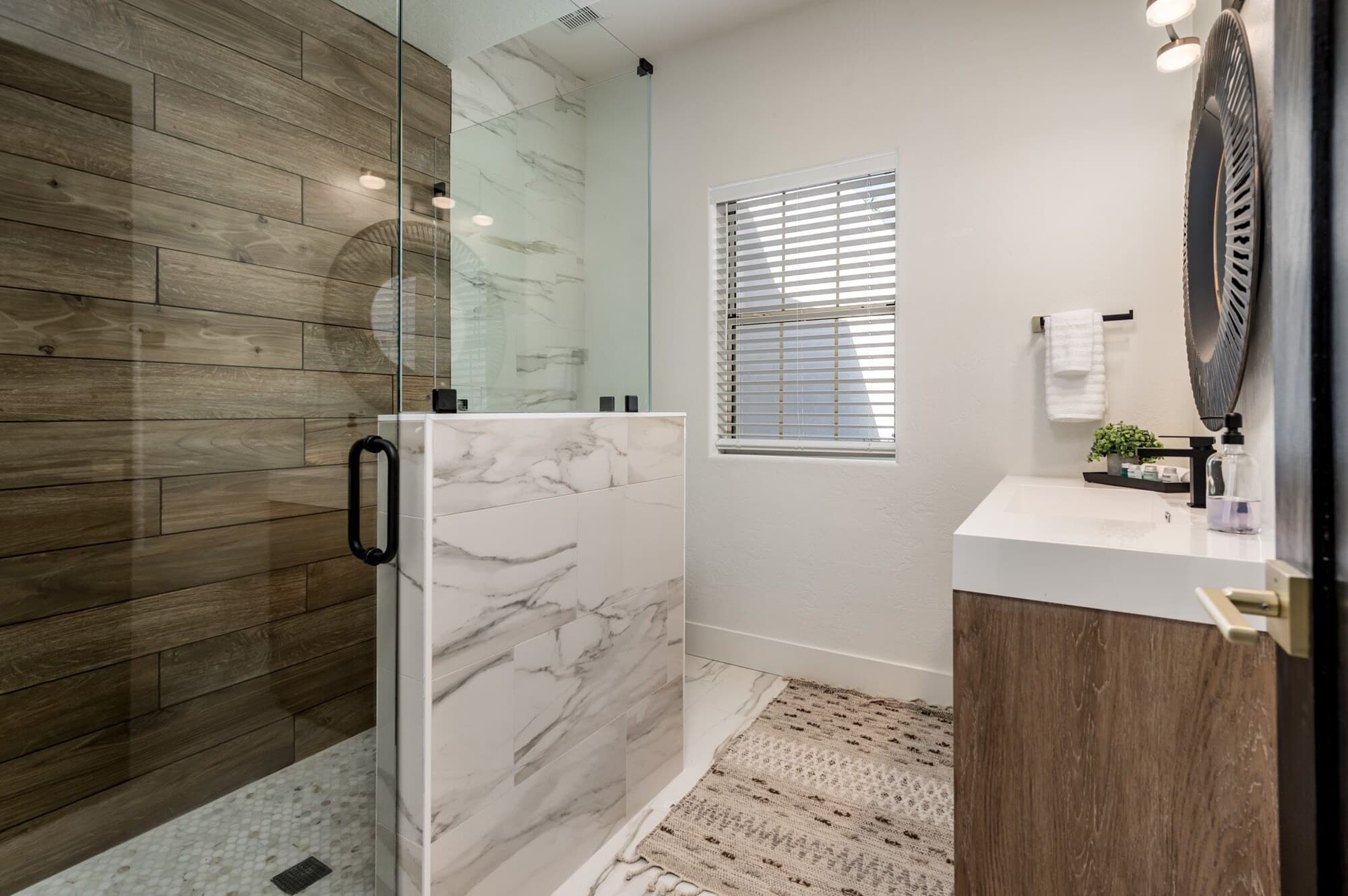 Marble and wood-tile walk-in shower