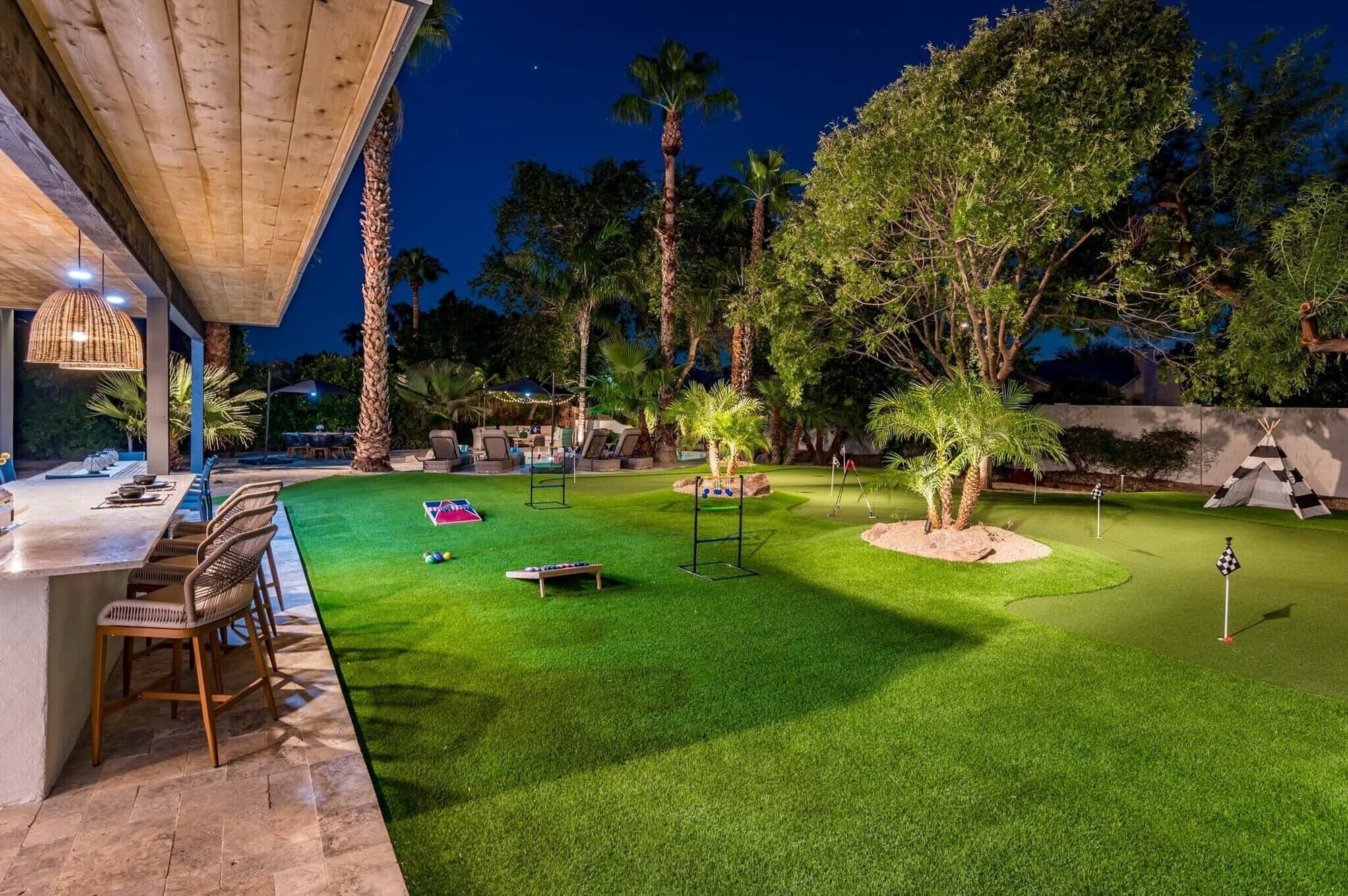 Resort backyard with putting green and yard games